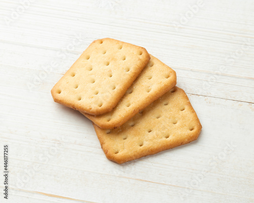 Cracker cookies on white wooden table background.