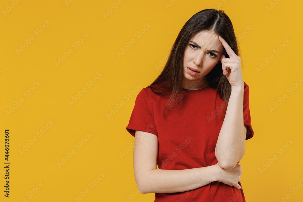 Sick ill young brunette woman 20s wears basic red t-shirt rub temples has headache suffer from migraine feel bad seedy isolated on yellow background studio portrait. Healthy lifestyle disease concept Sick ill young brunette woman 20s wears basic red t-shirt rub temples has headache suffer from migraine feel bad seedy isolated on yellow background studio portrait. Healthy lifestyle disease concept