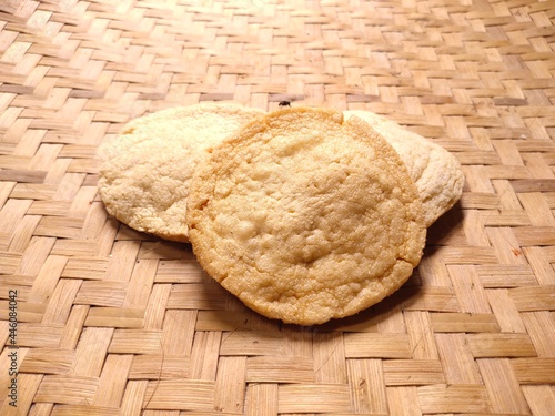 selective focus on Indonesian specialties (kemplang crackers) on woven bamboo background photo