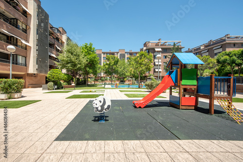 Communal recreational area for children, swings, slides and swimming pool in the center of a neighborhood community