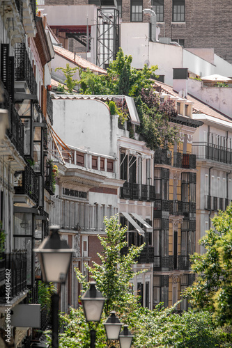 Old facades with balconies and wrought iron gazebos on a street in the center of Madrid