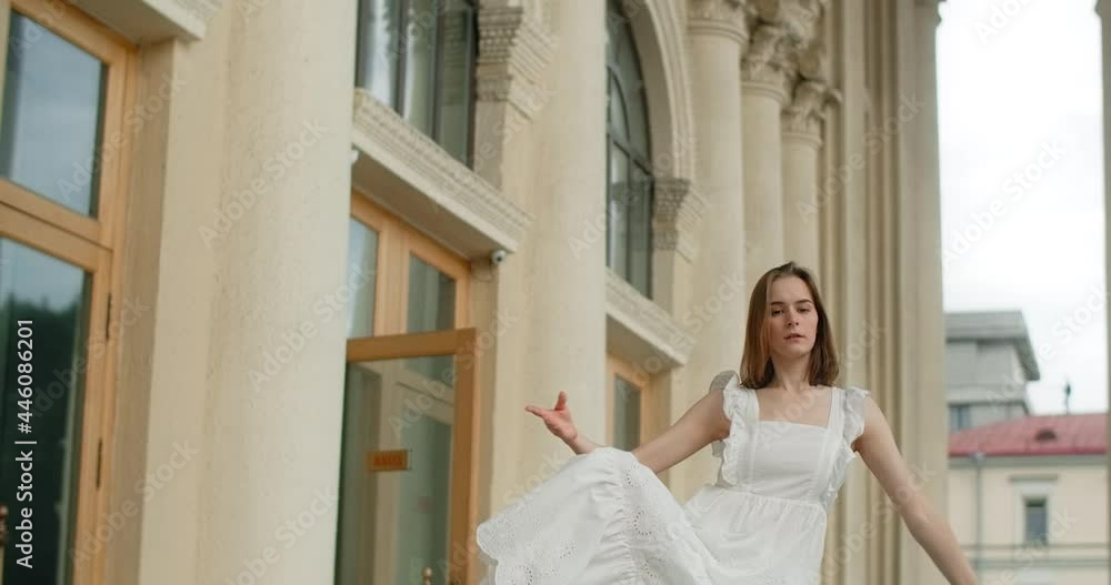 Young dancer woman in white dress whirls in the gallery of columns architectural complex in slow motion, balerina dances outdoors, 4k 120 fps Prores HQ Young dancer woman in white dress whirls in the gallery of columns architectural complex in slow motion, balerina dances outdoors, 4k 120 fps Prores HQ