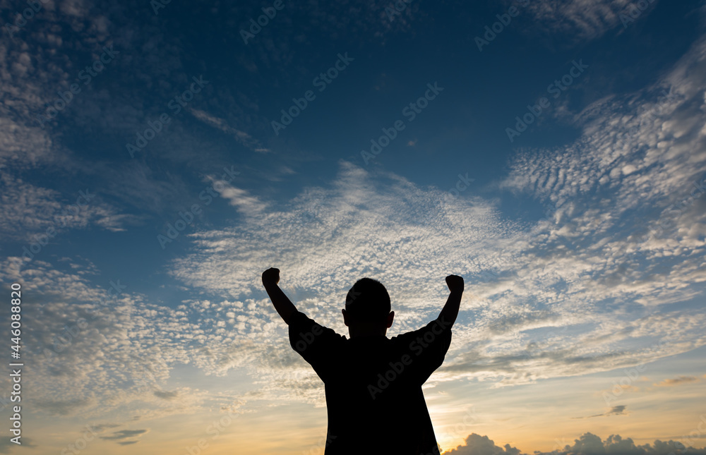 Fototapeta premium Cheerful boys celebrating and proudly outstretching his arms towards sky at stunning sunset.