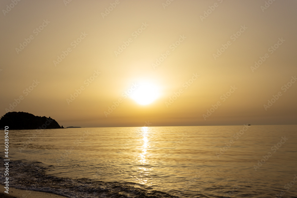 Beautiful view of seaside at dawn. Sunrise view with waves and sea. Landscape of rising sun over the sea in Cirali, Antalya, Turkey.
