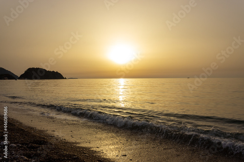Beautiful view of seaside at dawn. Sunrise view with waves and sea. Landscape of rising sun over the sea in Cirali  Antalya  Turkey.