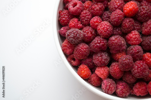 A close-up shot of a fresh raspberry in a white cup - perfect for a culinary blog diet and the benefits of natural vitamins. Healthy lifestyle. There is a place for your inscription.