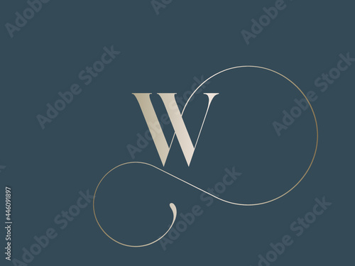 Letter W logo.Calligraphic signature icon.Decorative swirl lettering sign isolated on dark background.Alphabet initial.Elegant, luxury, wedding, beauty, spa style.Gold color.