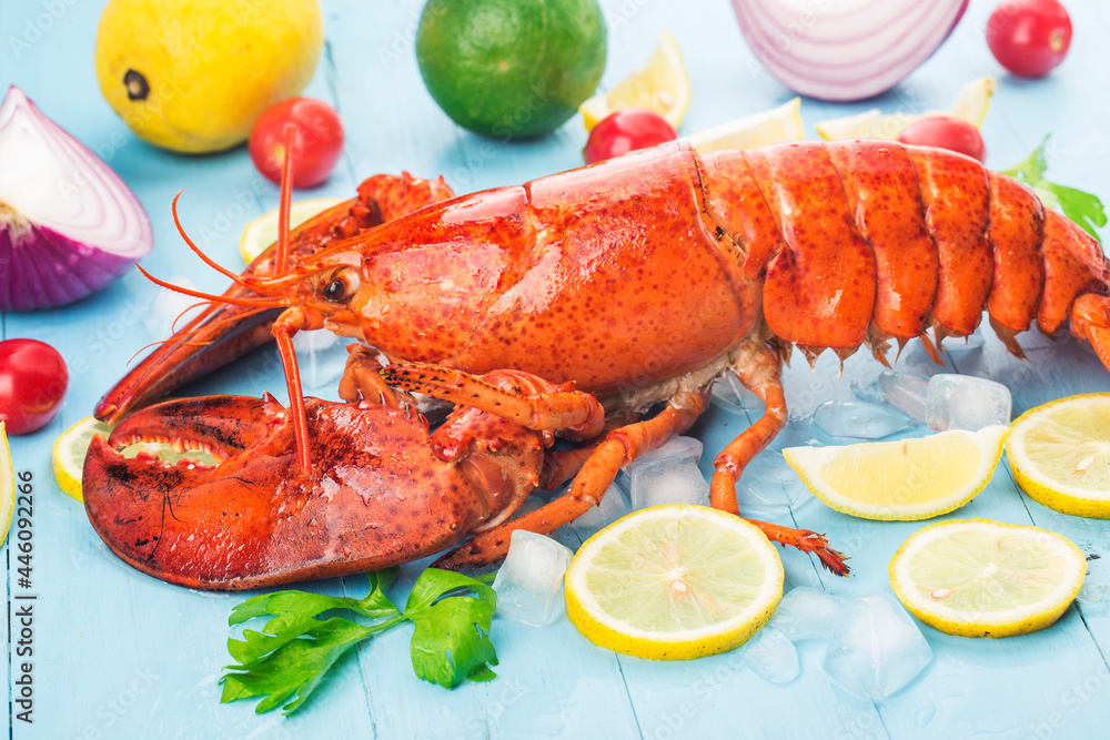 Seafood feast,Lemon and fresh Boston lobster on the ice Seafood feast,Lemon and fresh Boston lobster on the ice