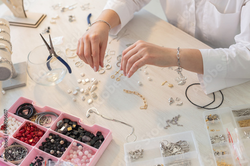 Fototapeta Professional jewelry designer making handmade jewelry in studio workshop close up