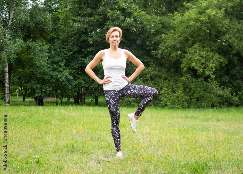 Beautiful young woman goes in for sports in the park in nature. The woman is engaged in fitness in sportswear. Beautiful young woman goes in for sports in the park in nature. The woman is engaged in fitness in sportswear.
