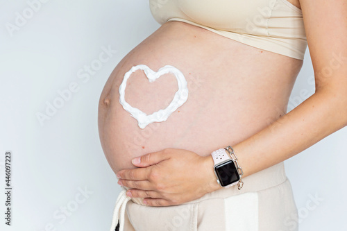 Wallpaper Mural Closeup photography of young Woman touching hands her naked big belly Isolated on white background with copy space. Skin care with moisturising cream against stretch marks. Emotional loving pregnancy Torontodigital.ca