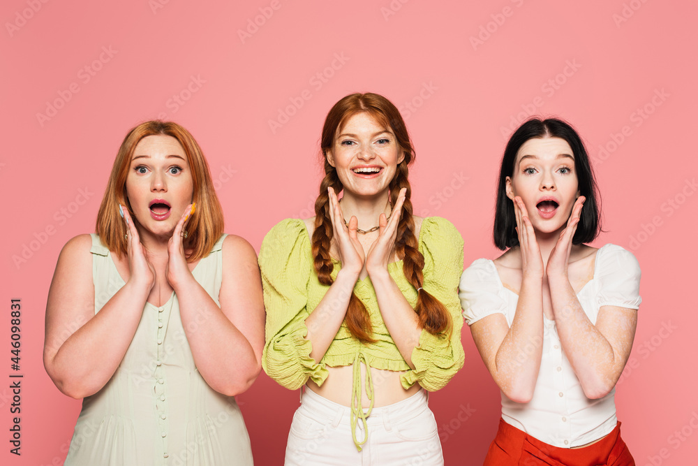 Excited stylish body positive friends looking at camera isolated on pink Excited stylish body positive friends looking at camera isolated on pink