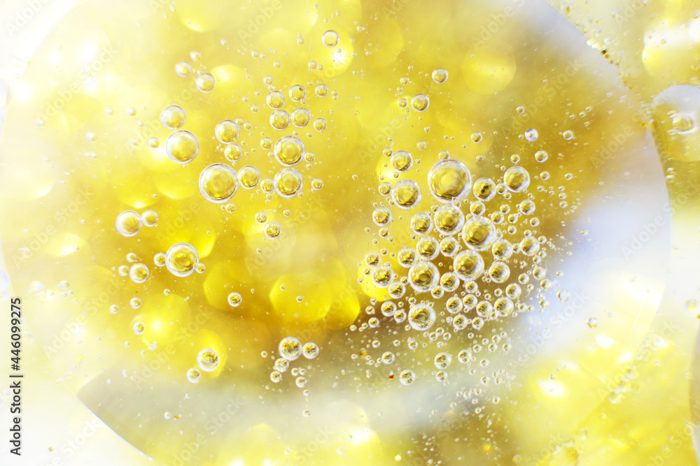 Gold Oil bubbles close up. circles of water macro. abstract shiny yellow background