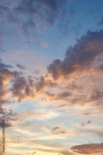 Fototapeta Naklejka Na Ścianę i Meble -  Beautiful evening blue sky at sunset with flaming bright light clouds. A warm summer evening at sunset. Bright sunset.