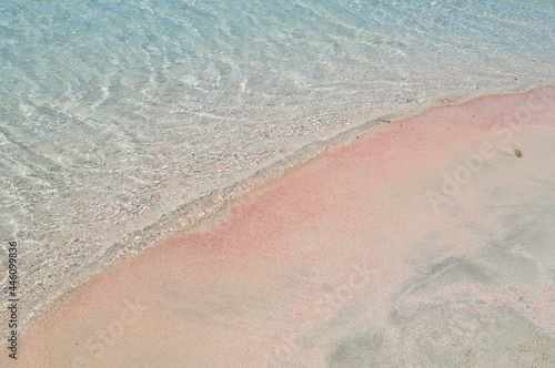 White pink sand and blue water close-up as an abstract background.