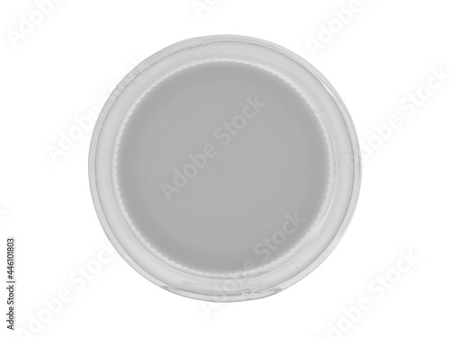 Plastic transparent jar, closed with a lid. Isolated on a white background, close - up view from above