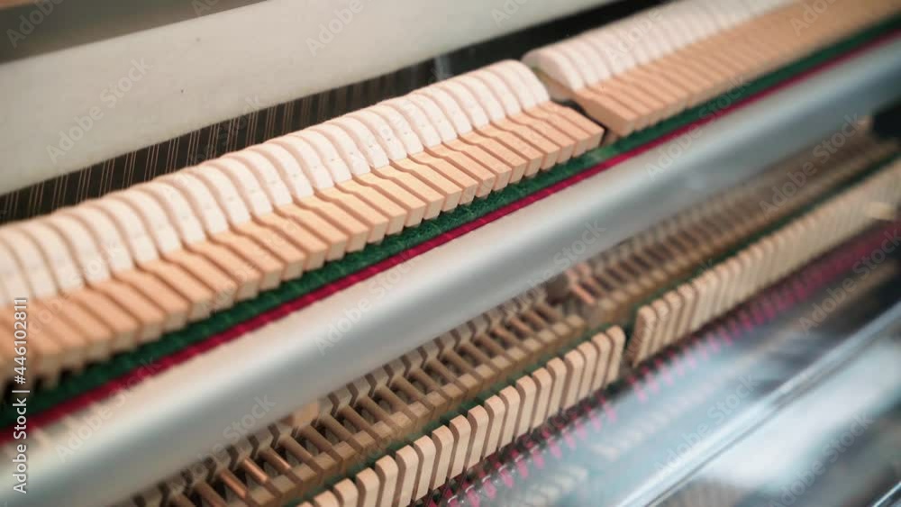 Mechanical piano mechanism close up with hammers and strings, Pan right reveal shot Mechanical piano mechanism close up with hammers and strings, Pan right reveal shot