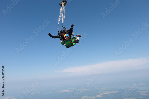 Skydiving. Tandem jump. Man and woman are in the sky.