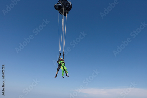 Skydiving. Tandem jump. Man and woman are in the sky.