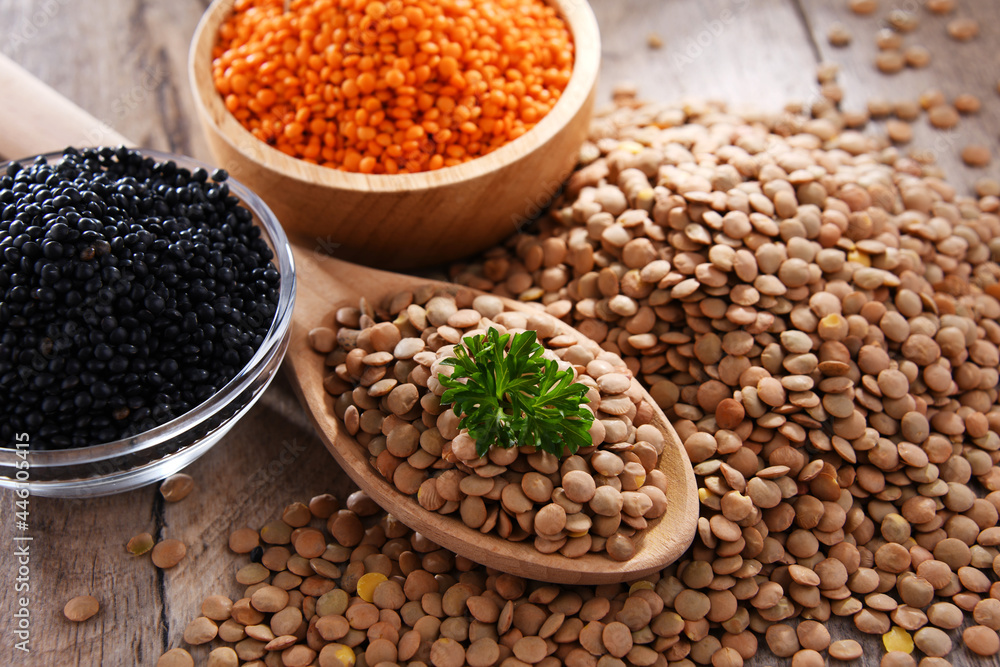 Composition with three sorts of lentils on wooden table Composition with three sorts of lentils on wooden table