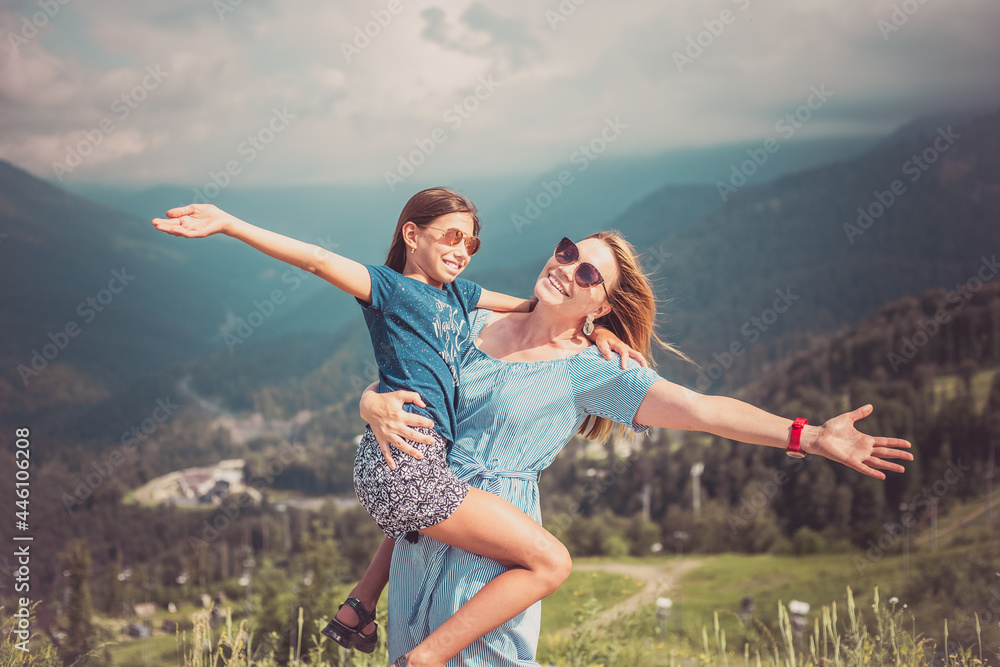 Mother hugging daughter. Holiday trip concept Mother hugging daughter. Holiday trip concept