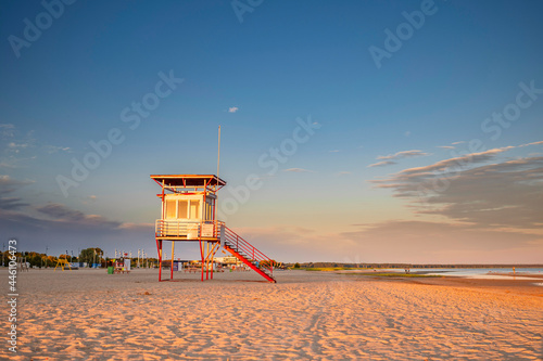 Fototapeta Naklejka Na Ścianę i Meble -  Parnu beach in Estonia during sunny summer sunset, life guard tower in foreground