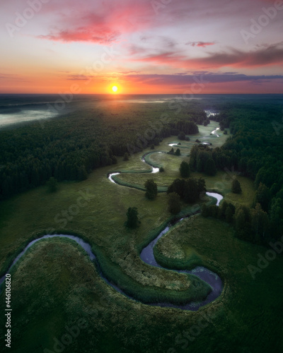 Soomaa national park and small curvy river from birds eye view during sunrise.