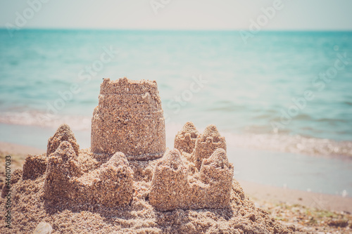Sand castle standing on the beach. Travel vacations concept.
