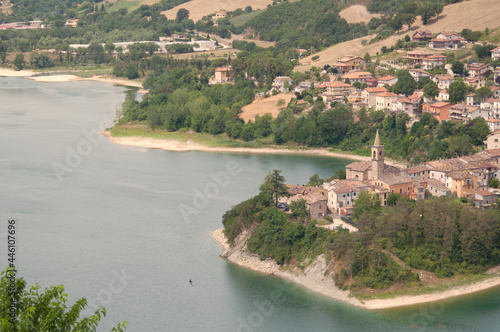 Aerial shot of the houses by the beautiful lake of Mercatale Marche captured in Italy photo