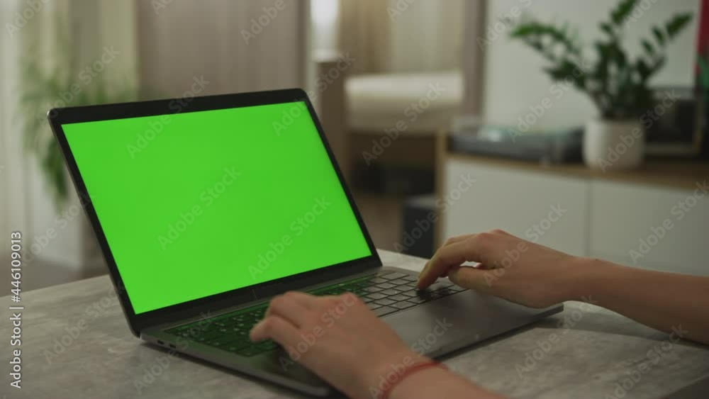 Hands typing on a laptop with chroma key green screen indoors Hands typing on a laptop with chroma key green screen indoors