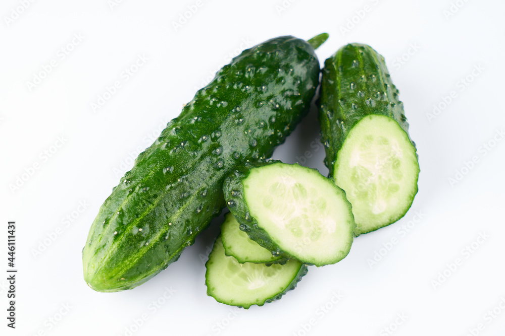 Set of fresh whole and sliced cucumbers on white background. Garden cucumber green wallpaper backdrop design Set of fresh whole and sliced cucumbers on white background. Garden cucumber green wallpaper backdrop design
