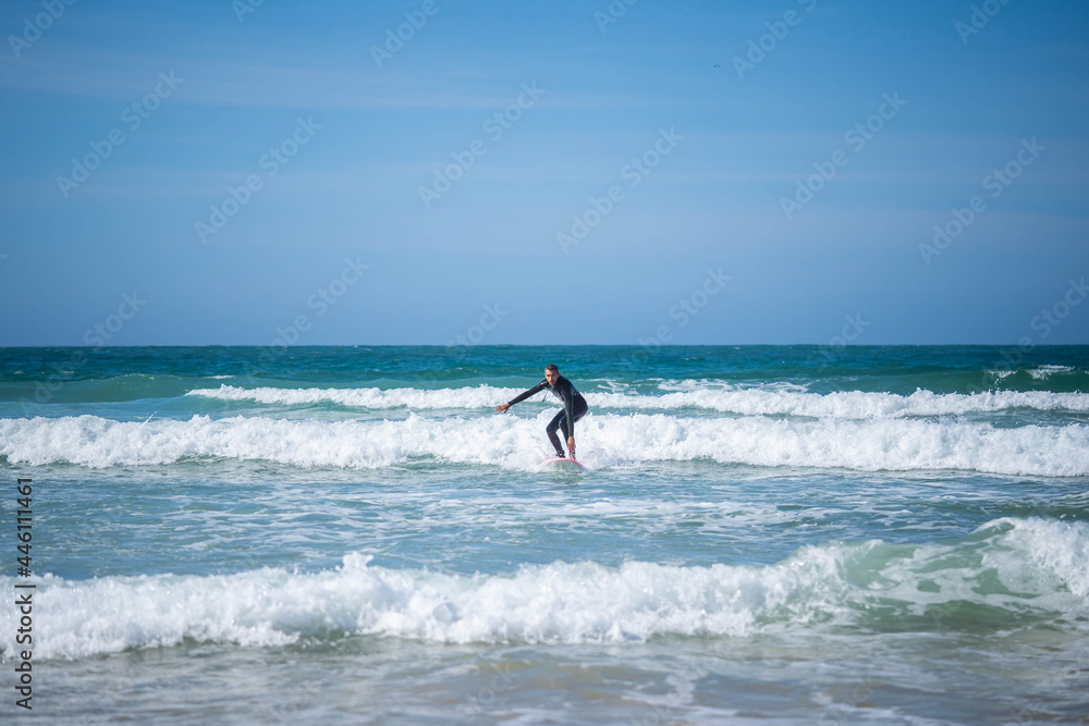 guy on a surfboard on bent legs. Concept: balance, stability, coordination guy on a surfboard on bent legs. Concept: balance, stability, coordination
