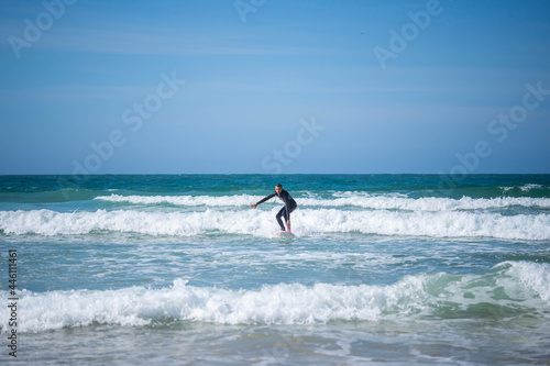 guy on a surfboard on bent legs. Concept: balance, stability, coordination