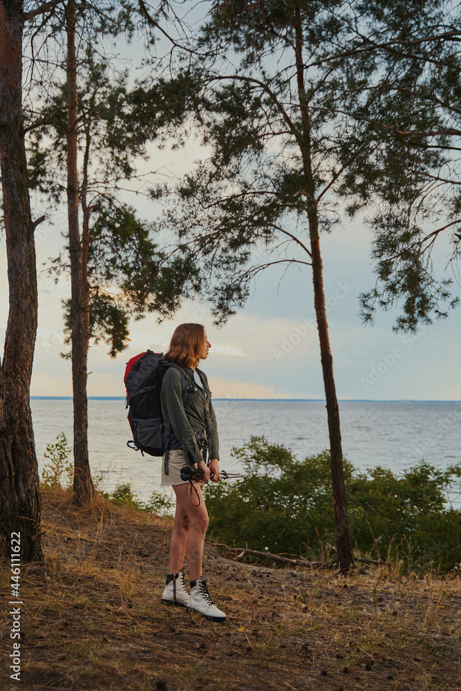 Tourist admiring the lake view in a forest Tourist admiring the lake view in a forest
