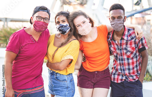 Group of multiracial friends taking photo with face mask on - Young people having fun in holiday - new lifestyle concept © BooNKer