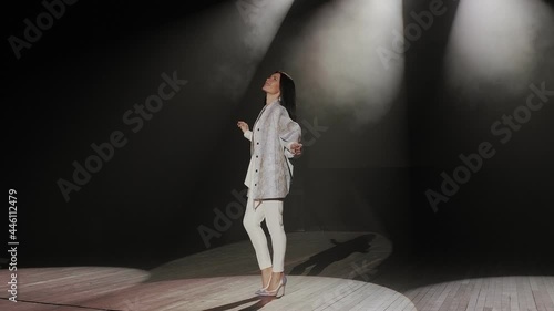 Wallpaper Mural A slender female model with long black hair poses on a concert stage in the dark Torontodigital.ca