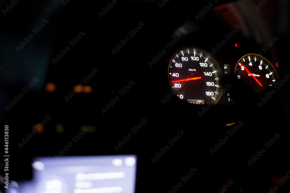 Sports car dashboard at night. Close up