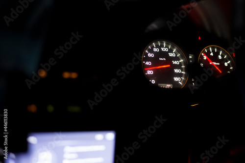 Sports car dashboard at night. Close up