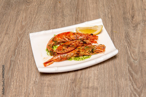 Grilled prawns with typical Andalusian green sauce with a little lemon to garnish.