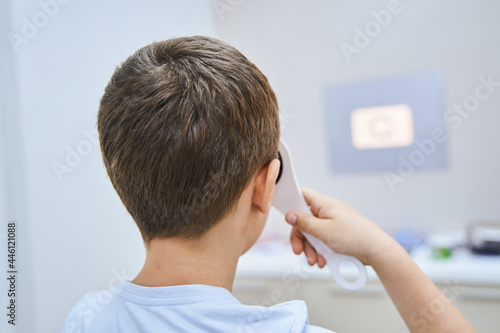 Little boy having eye examination in modern clinic