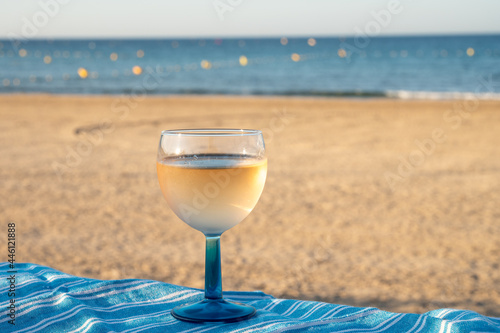 Summer time in Provence, drinking of cold gris rose wine on sandy beach and blue sea near Toulon, Var department, France photo