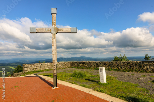 Kreuz auf der aussichtsplattform an der hochwaldbaude mit grenzstein im zittauer gebirge photo