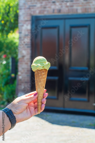 Eating on fresh made italian ice cream on street, summer vacation