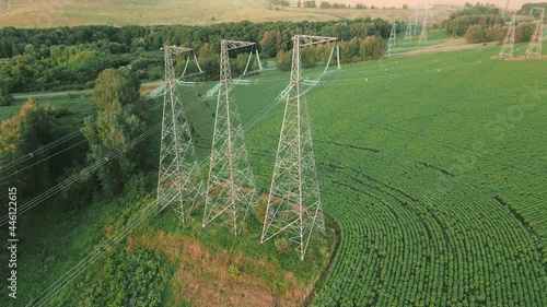 High voltage power line on industrial electricity line tower. Energy transmisson with overhead power line photo