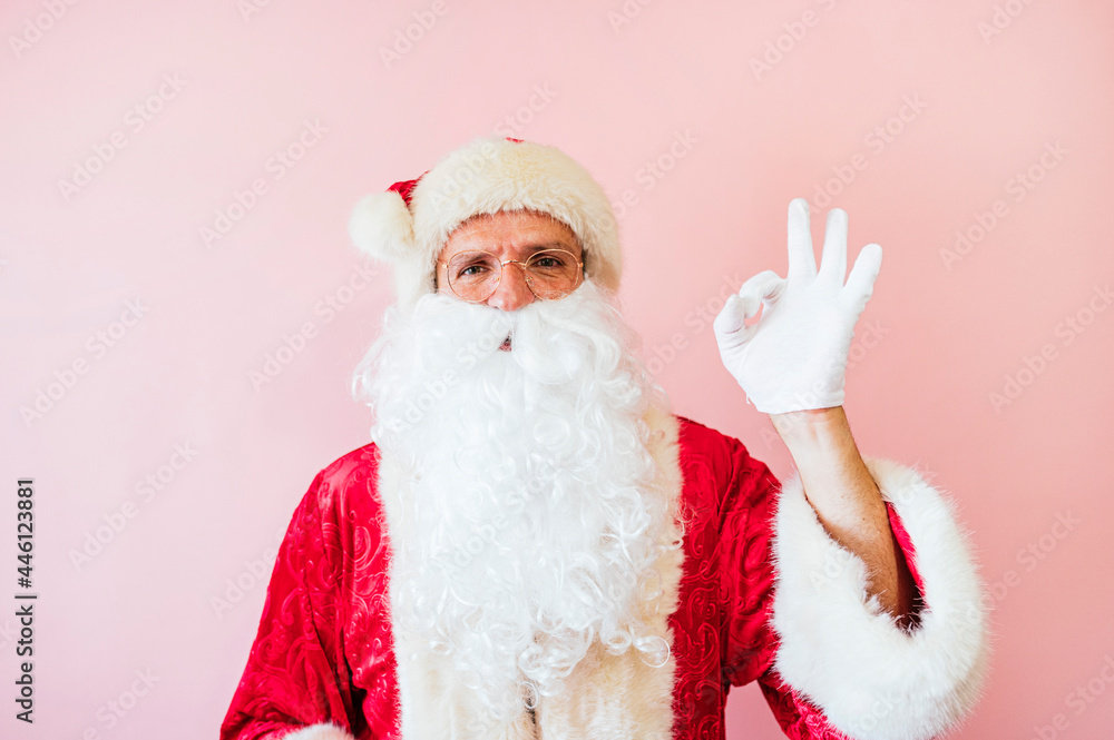 Man dressed as Santa Claus making OK gesture
