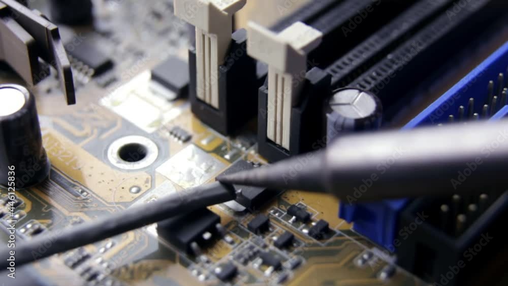 Soldering of electronic circuit board with electronic components. Soldering station. Engineers repair circuit board with soldering iron. Computer repair concept Soldering of electronic circuit board with electronic components. Soldering station. Engineers repair circuit board with soldering iron. Computer repair concept