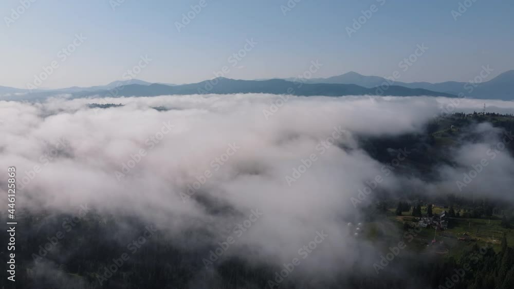 Cinematic beautiful drone shot of clouds on sunny day, countryside, summer mountain peaks in distance on horizon. Inspiring and mesmerizing calm tranquil. Travel destination idyllic nature concept Cinematic beautiful drone shot of clouds on sunny day, countryside, summer mountain peaks in distance on horizon. Inspiring and mesmerizing calm tranquil. Travel destination idyllic nature concept