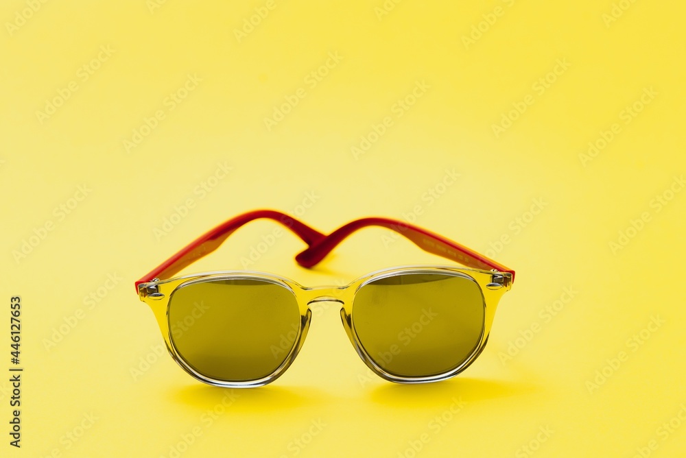 Stylish sunglasses on a yellow background High quality photo Sunglasses. Stylish sunglasses on a yellow background High quality photo Sunglasses.