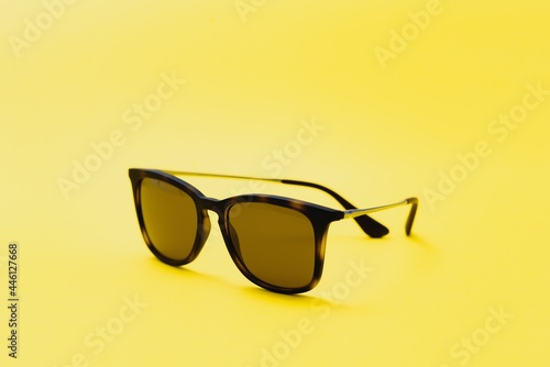 Stylish sunglasses on a yellow background High quality photo Sunglasses.