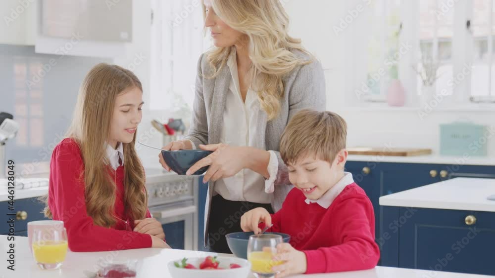 Mother Wearing Business Suit Having Breakfast With Children In School Uniform Before Work Mother Wearing Business Suit Having Breakfast With Children In School Uniform Before Work